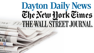 A stack of newspapers including Dayton Daily, New York Times, and Wall Street Journal