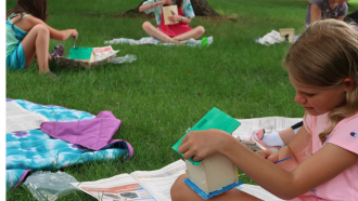 Tweens on lawn blankets and make crafts