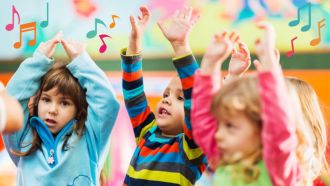 Small children waving arms in the air as music notes float overhead.