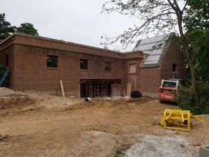 A large hole cut into the exterior brick of the library's east wall