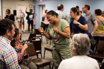 people laugh and interact in the library meeting room