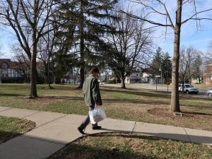 librarian walking to patrons house with books