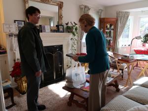 librarian and patron looking at the books in her home