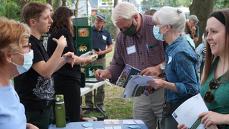 plant experts and community members discuss native plants outside the library