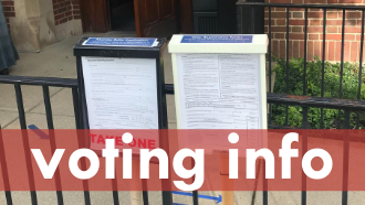 Text: voting info photo: two form boxes posted outside the library