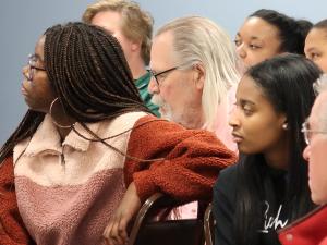 people listen attentively to a presenter