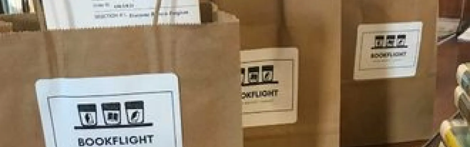 Librarians select books per your suggestions, then place them in brown bags labeled "Book Flight" ready for pickup.
