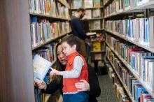 mother and child browse the stacks