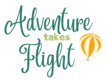 Hot air balloon floats beside the words "Adventure Takes Flight"